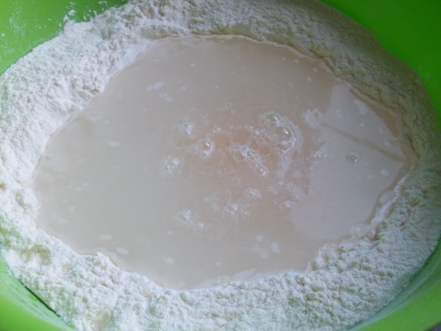 Add water to eggs and flour for Khinkali recipe