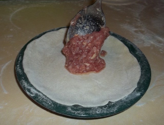 Adding the filling to Khinkali dough