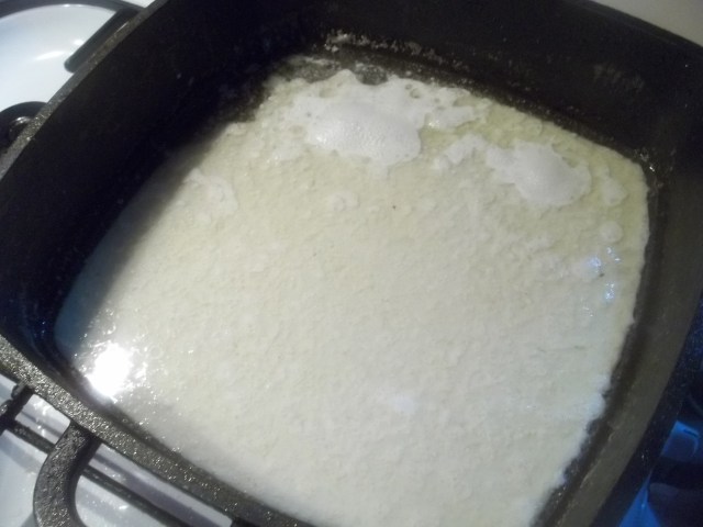 Heating Milk and Garlic for Racha Chicken Recipe