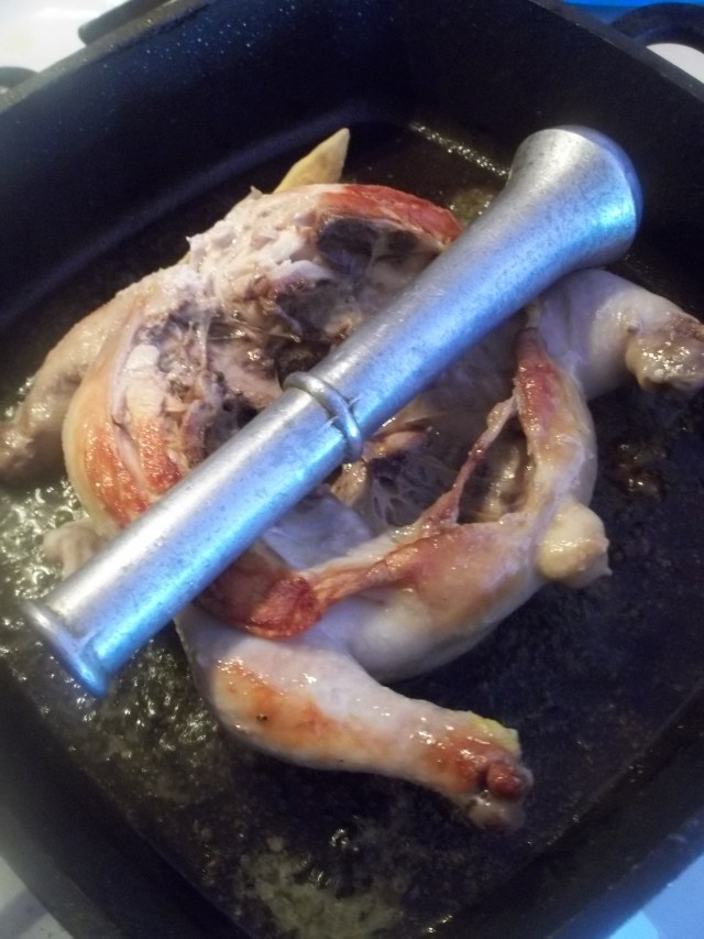Use a pestle to keep the chicken flat_Georgian Chicken with Nuts Recipe
