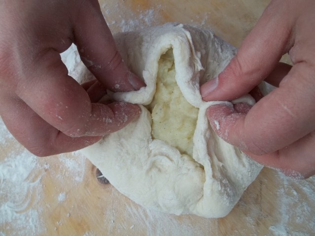 sealing-the-dough-for-khachapuri-with-potato-recipe