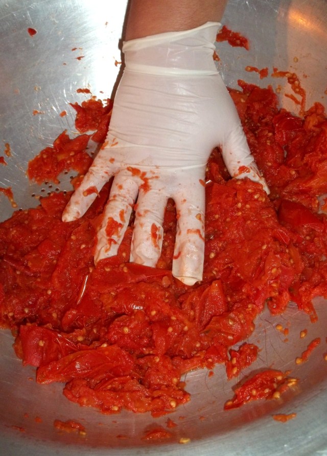 mashing-tomatoes-for-spicy-tomato-sauce-recipe