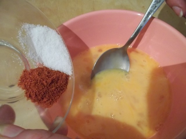 Adding Salt and Red Pepper to Beaten Eggs