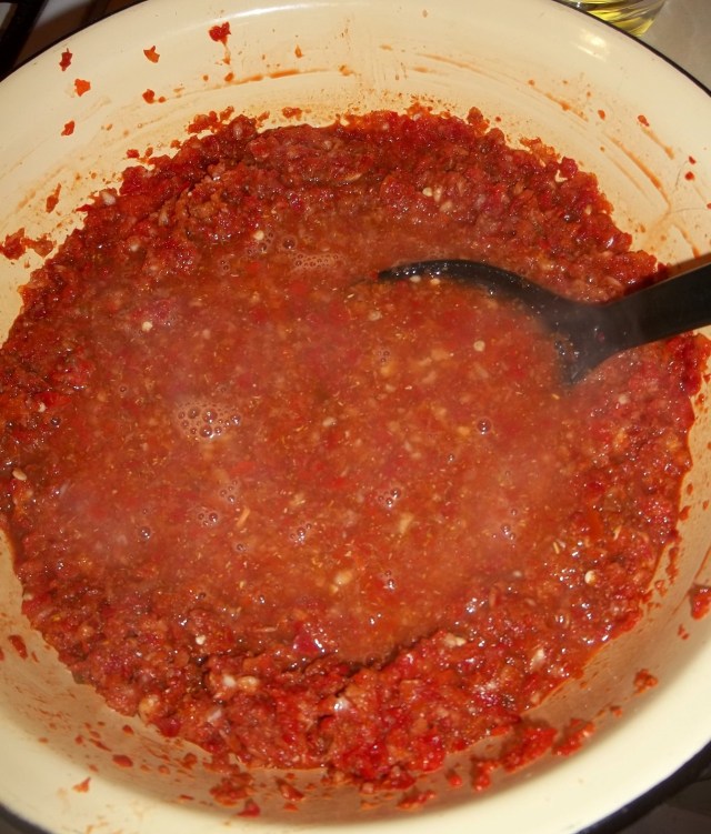 Adding Boiled Vinegar to Peppers and Garlic and Spices