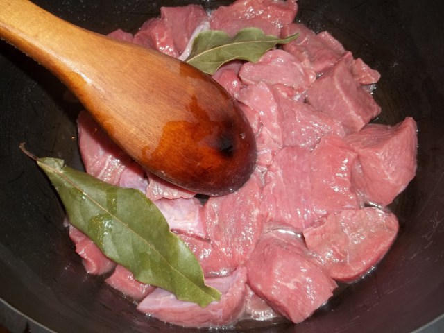 Adding Beef and Bay Leaves to a Pot - Copy