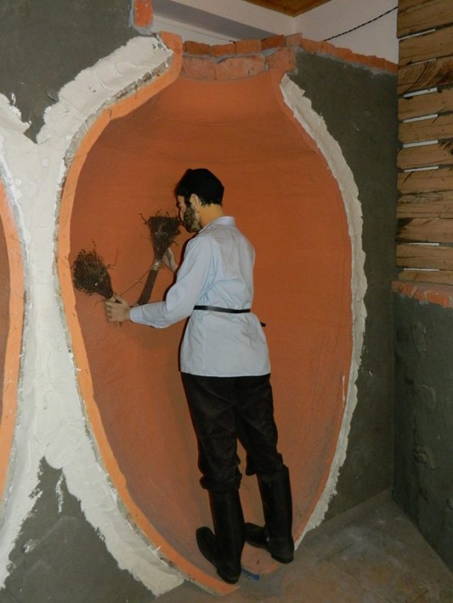 Cleaning a Qvevri exhibit at the Qvevri and Qvevri Wine Museum