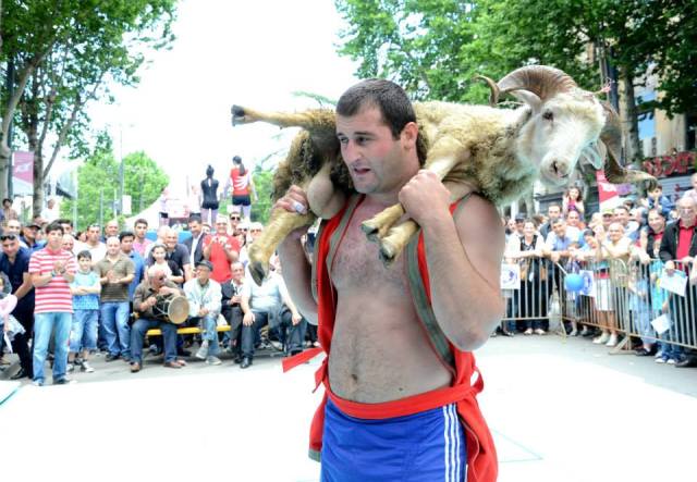 The winner of a wrestling competition receives his prize. Photo courtesy of the Ministry of Sport and Youth Affairs