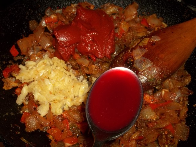 Adding Pomegranate Juice, Garlic and Tomato Puree