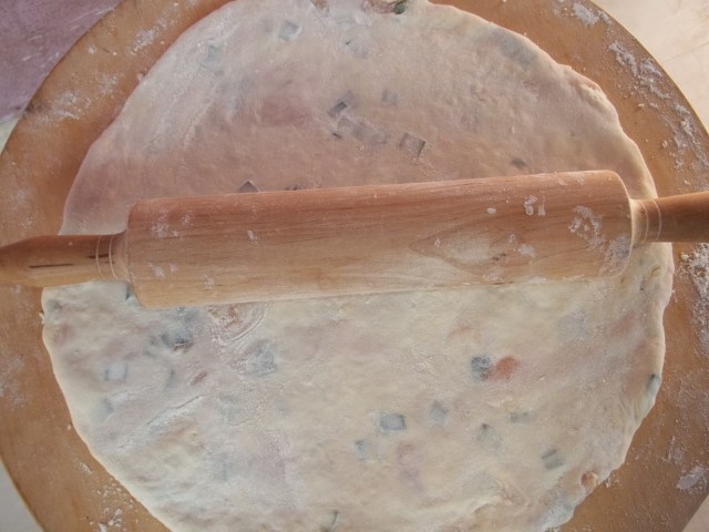 Carefully roll out the filled pastry