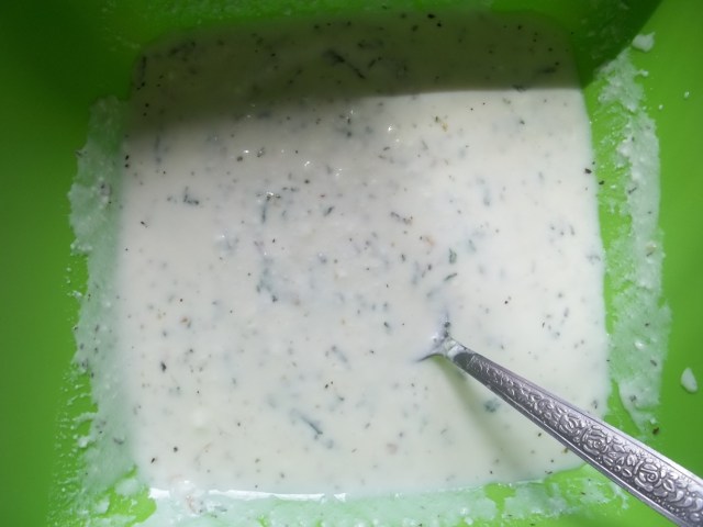 Mixing ground herbs and garlic with matsoni