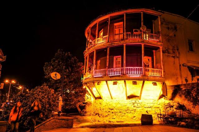 Illuminated balcony of a traditional building in Tbilisi